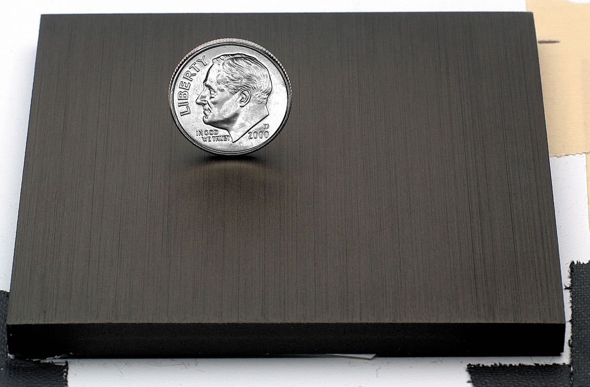 Sample of dark bronze anodized aluminum finish for sign letters.