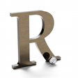 Light aged bronze sign letter R.