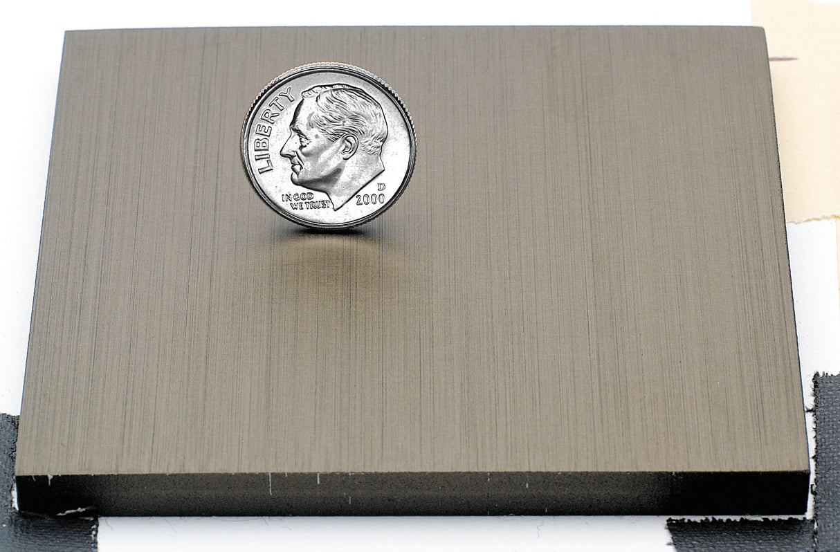 Sample of light bronze anodized aluminum finish for sign letters.