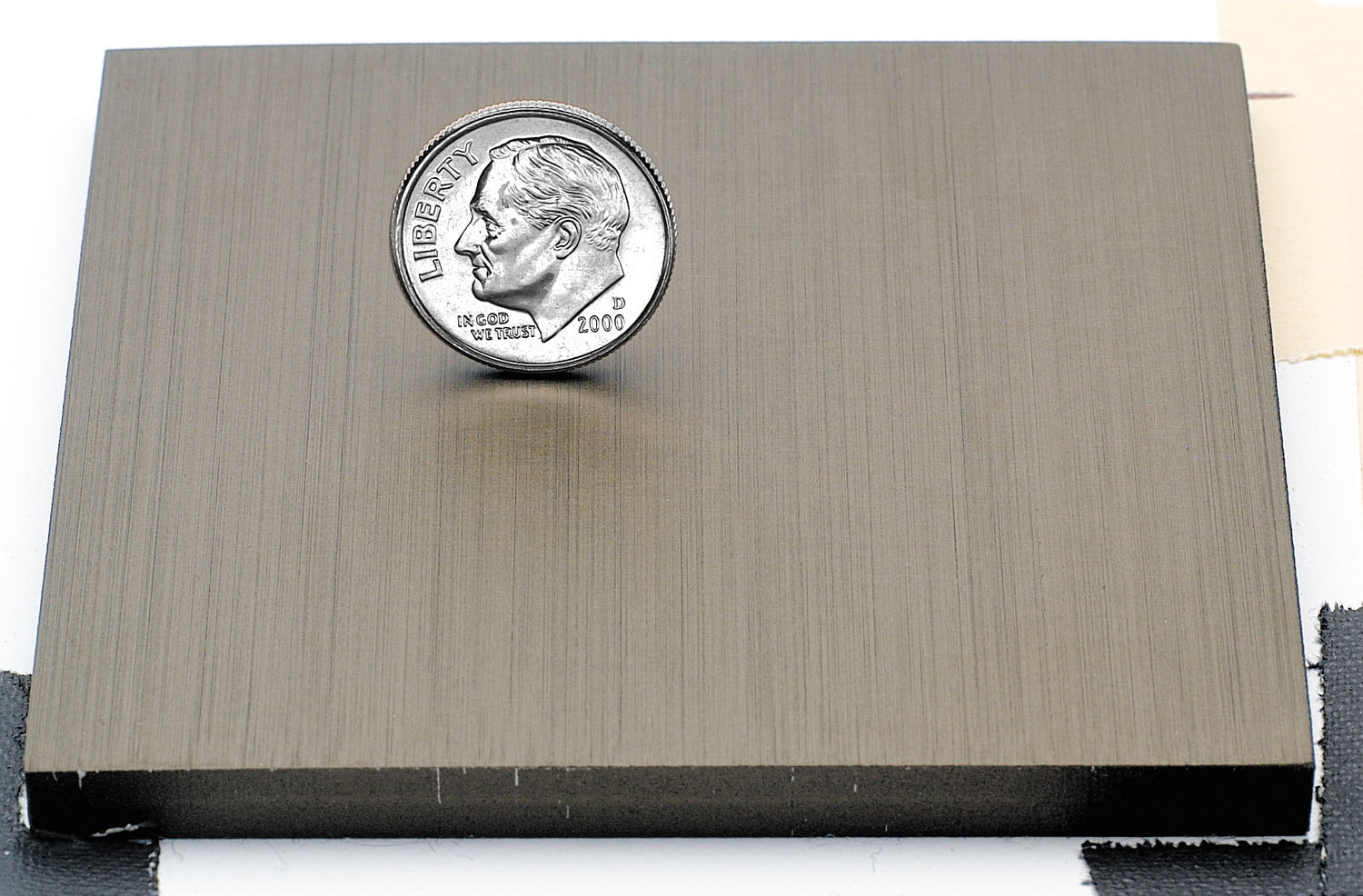 Sample of light bronze anodized aluminum finish for sign letters.