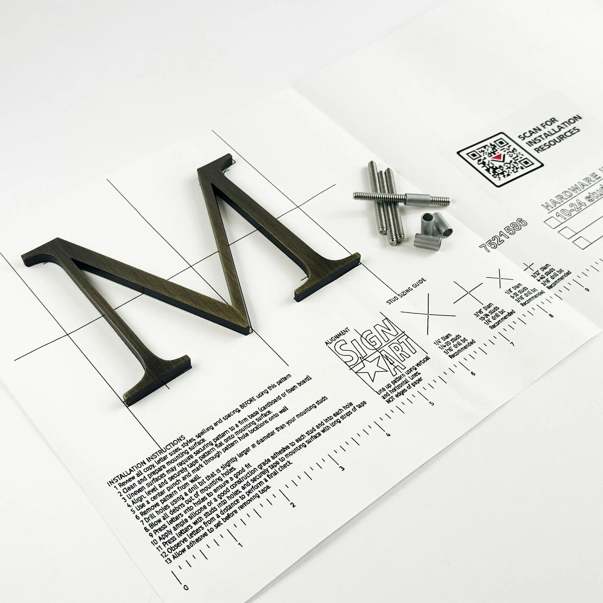 Heavily aged solid brass division 10 architectural sign letter on mounting template with hardware