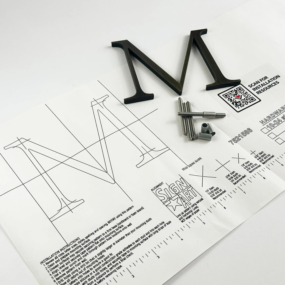 Heavily aged solid brass division 10 architectural sign letter on mounting template with hardware