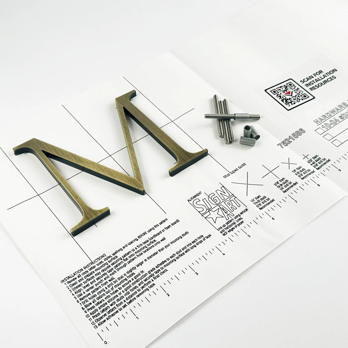Lightly aged solid brass division 10 architectural sign letter on mounting template with hardware
