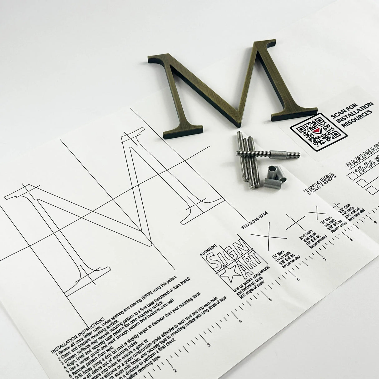 Lightly aged solid brass division 10 architectural sign letter on mounting template with hardware