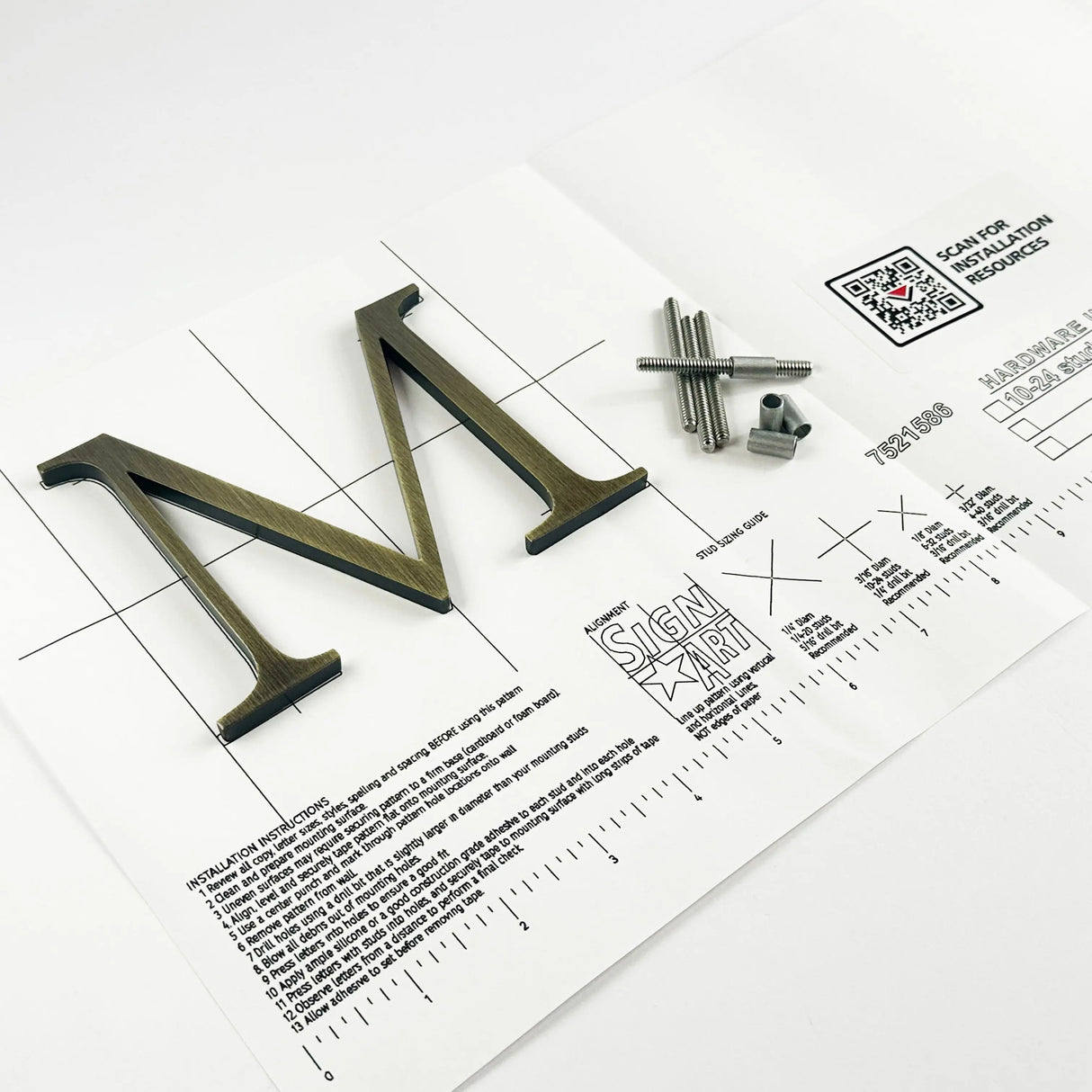 Aged solid brass division 10 architectural sign letter on mounting template with hardware