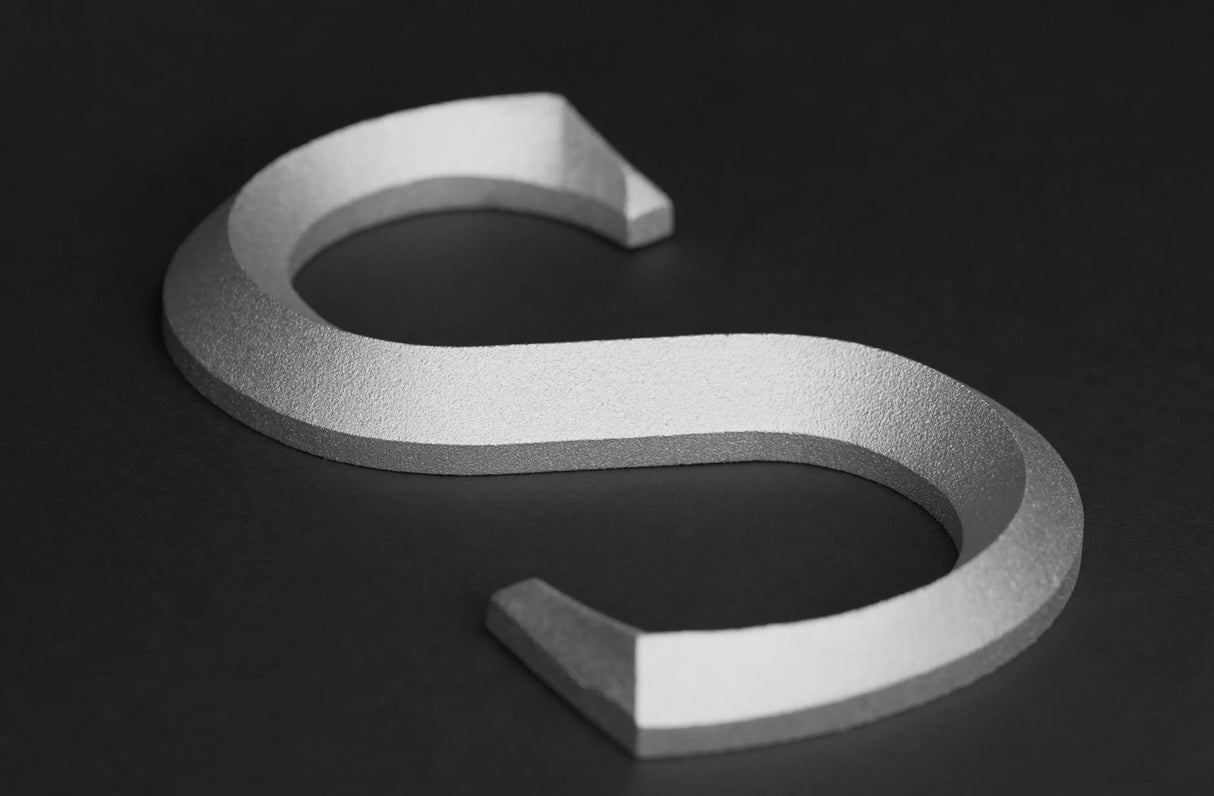 Prismatic faced cast aluminum sign letter