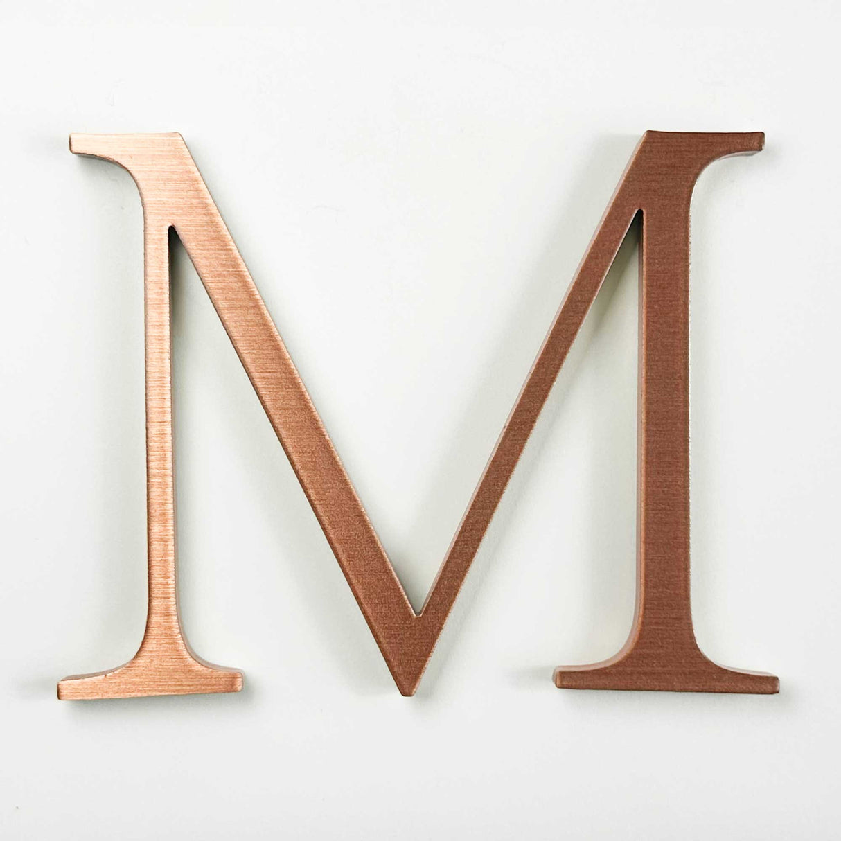 Horizontally brushed solid copper division 10 architectural sign letter