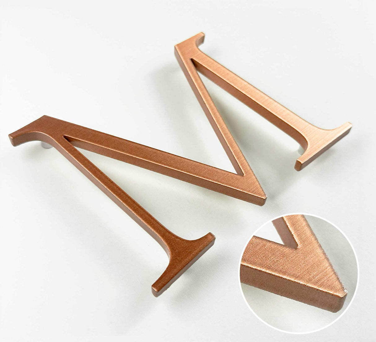 Horizontally brushed solid copper division 10 architectural sign letter with finish closeup