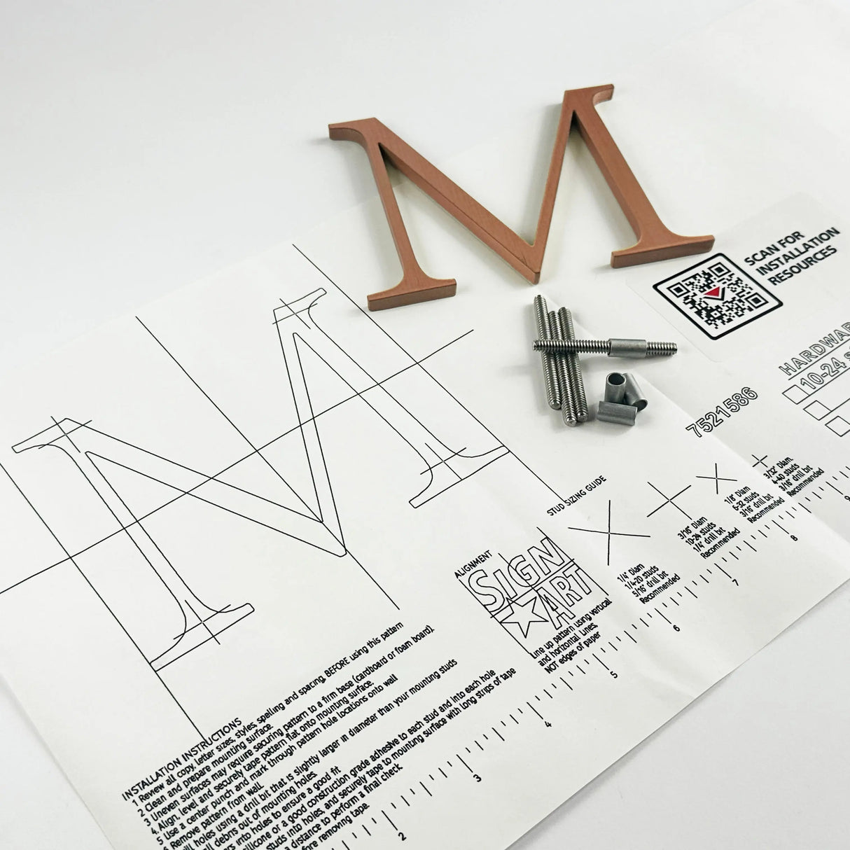 Vertically brushed solid copper division 10 architectural sign letter on mounting template with hardware