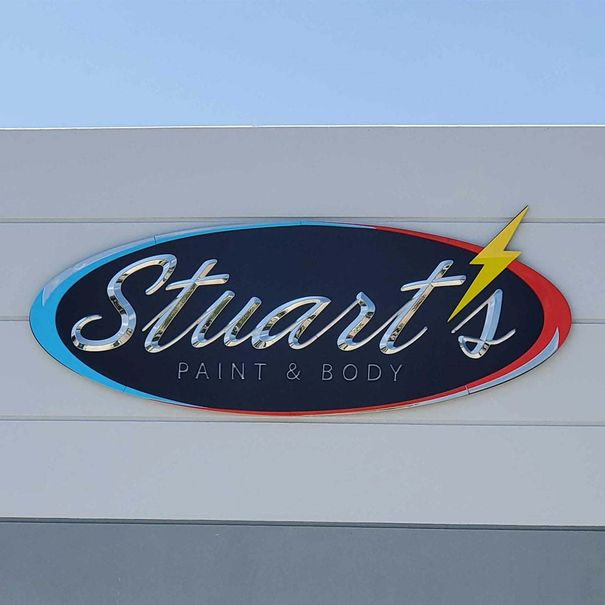 A formed plastic sign with polished chrome letters and multiple paint colors