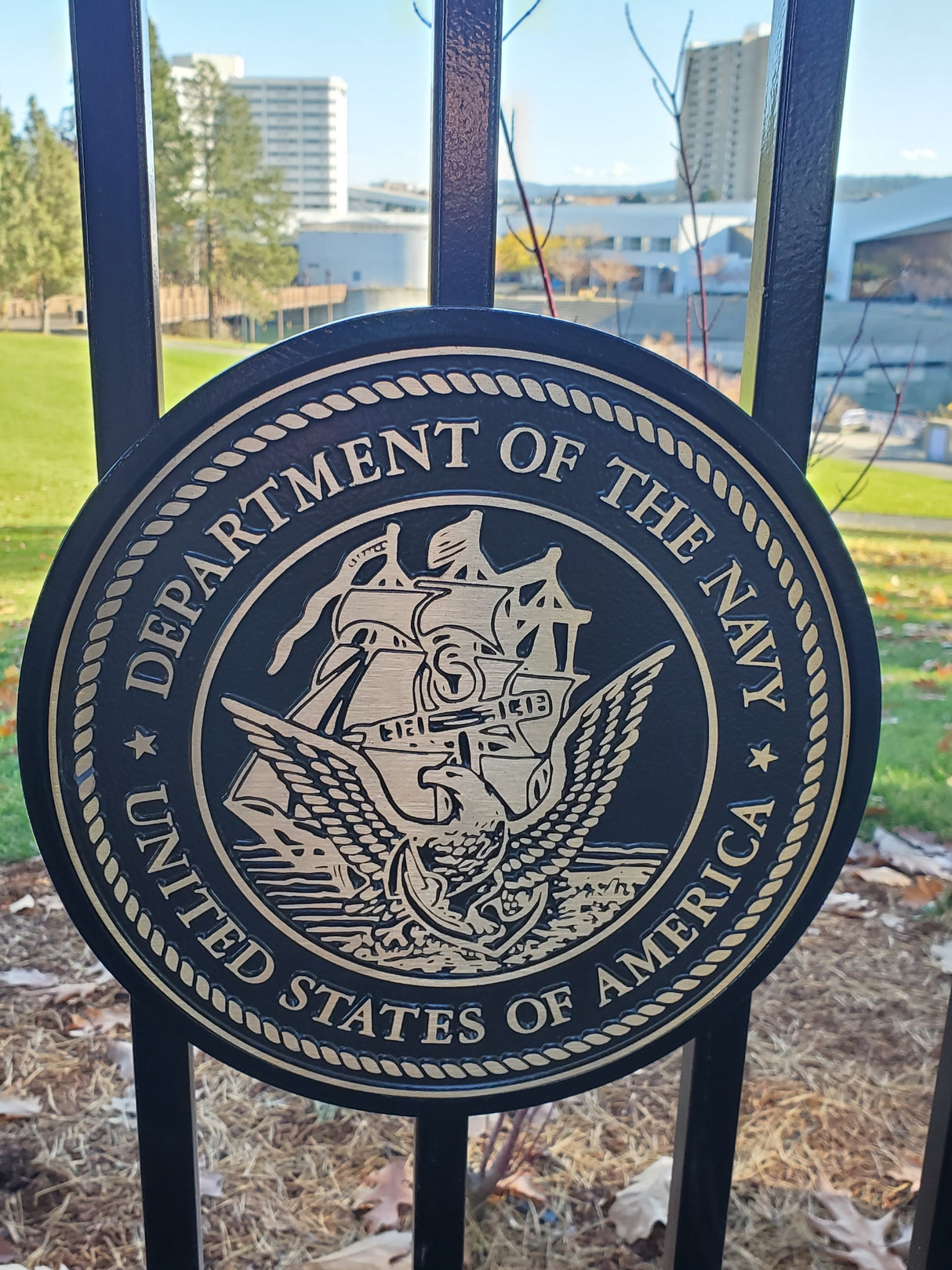 Bronze seal of the US Navy attached to a fence
