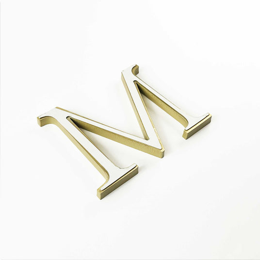 Solid brass division 10 architectural sign letter with double-sided tape mounting.