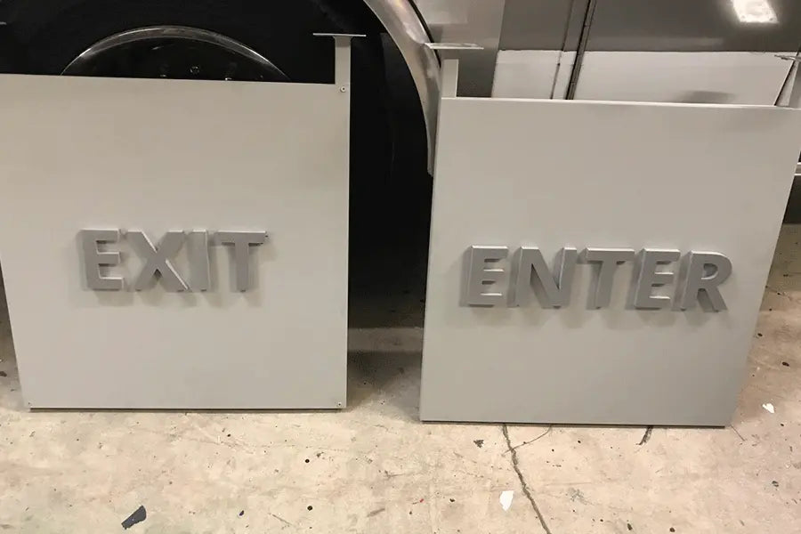 Exit and enter signs with cast aluminum sign letters