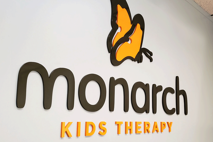 Lobby sign with painted acrylic sign letters and butterfly.