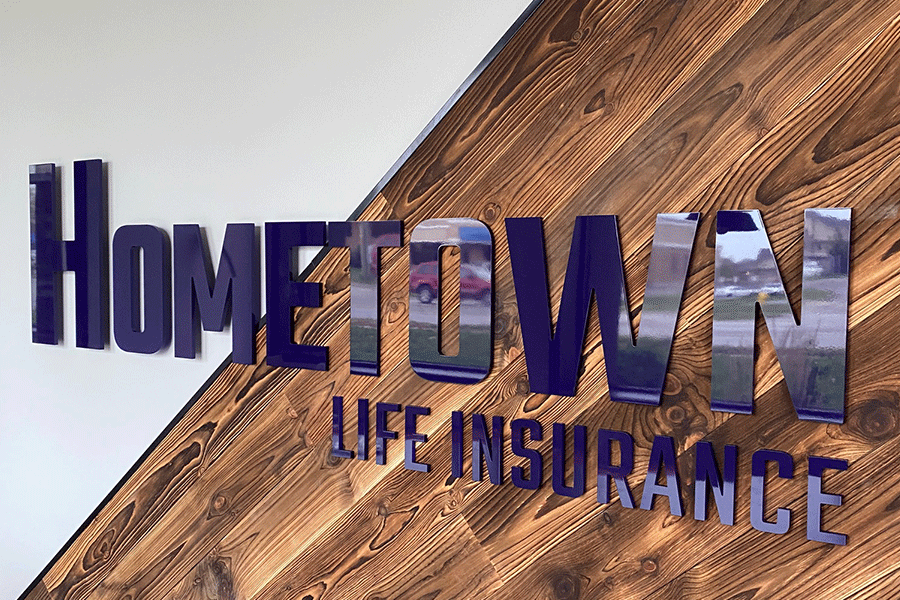 Insurance agency sign with purple painted acrylic sign letters.