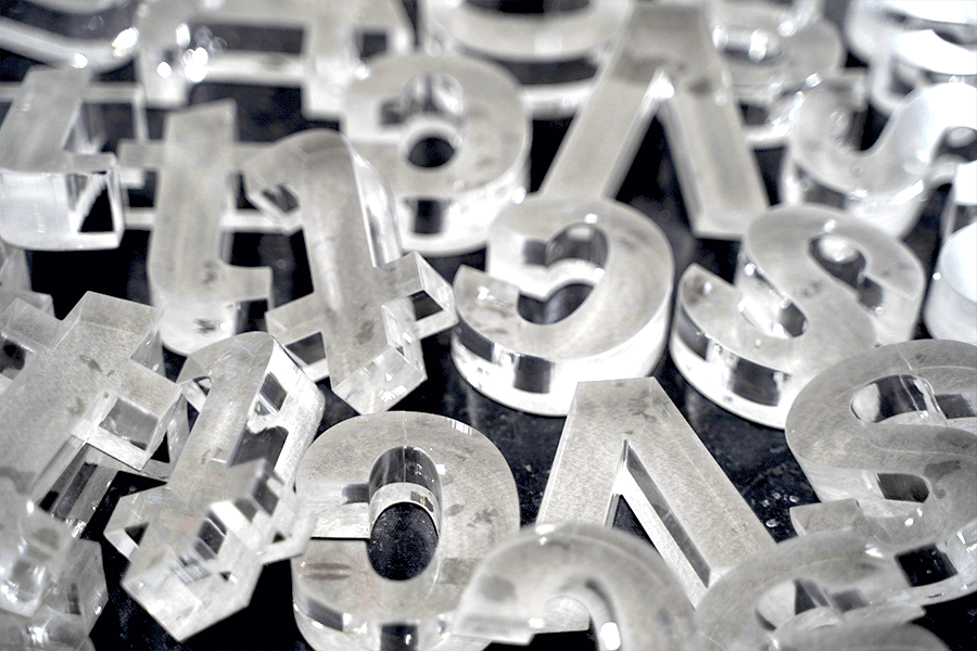 Pile of transparent clear acylic sign letters.