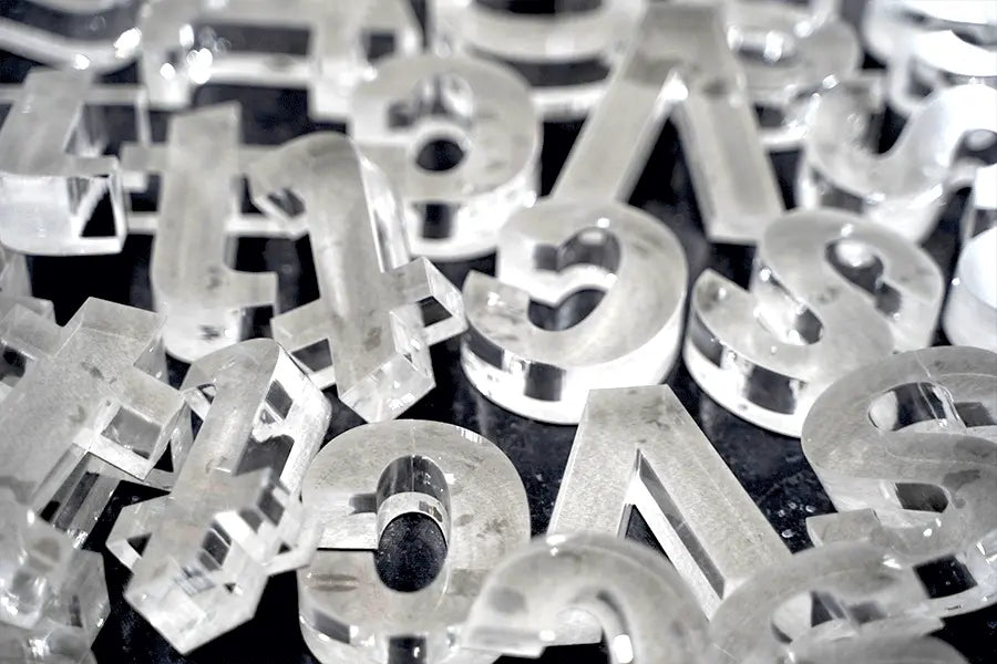 Pile of transparent clear acylic sign letters.