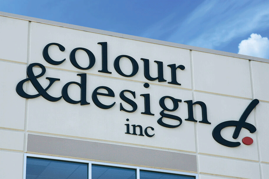 Storefront sign with unpainted black acrylic sign letters.