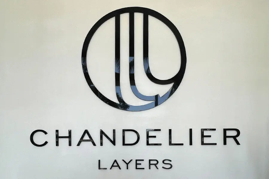 Lobby sign with unpainted black acrylic sign letters and shapes.