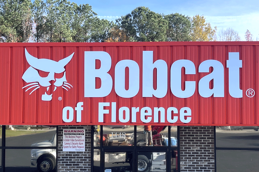 Exterior storefront sign with unpainted white acrylic sign letters.