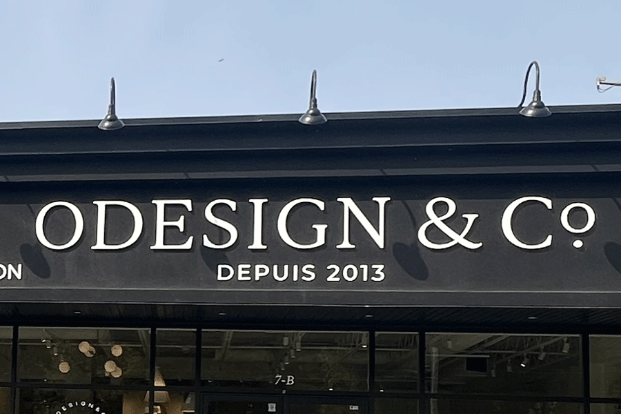 Furniture store sign with unpainted white acrylic sign letters.