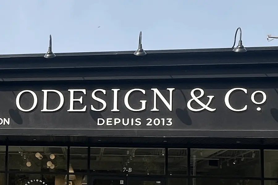 Furniture store sign with unpainted white acrylic sign letters.
