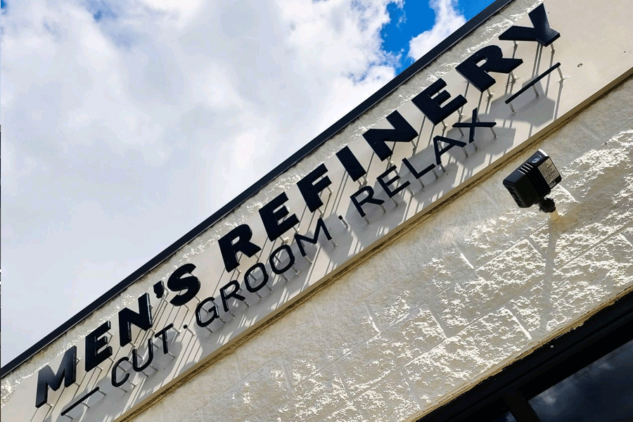 Barbershop sign with unpainted black acrylic sign letters.