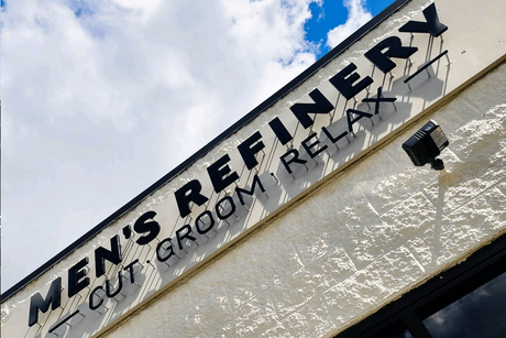 Barbershop sign with unpainted black acrylic sign letters.