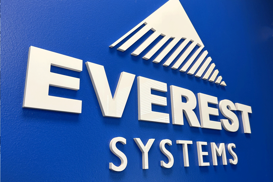 Lobby sign with unpainted white acrylic sign letters and shapes.