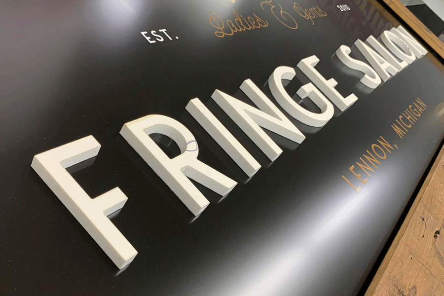 Beauty salon sign with unpainted white acrylic sign letters.