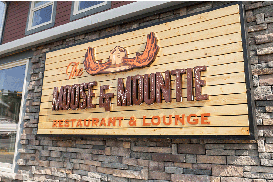 Flat cut acrylic and formed plastic restaurant sign for Moose and Mountie Restaurant and Lodge with brown and orange sign letters and a moose-antlered hat.