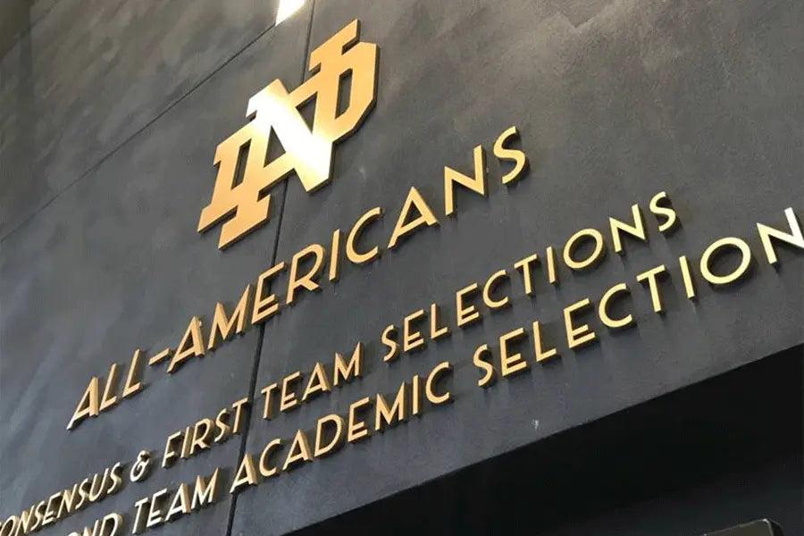 Commemorative wall with brass sign letters.