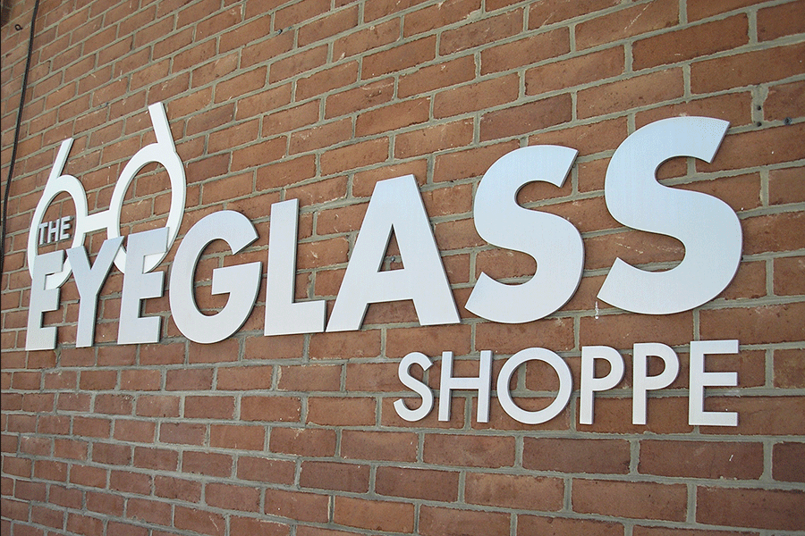 Exterior storefront sign with brushed stainless steel sign letters.
