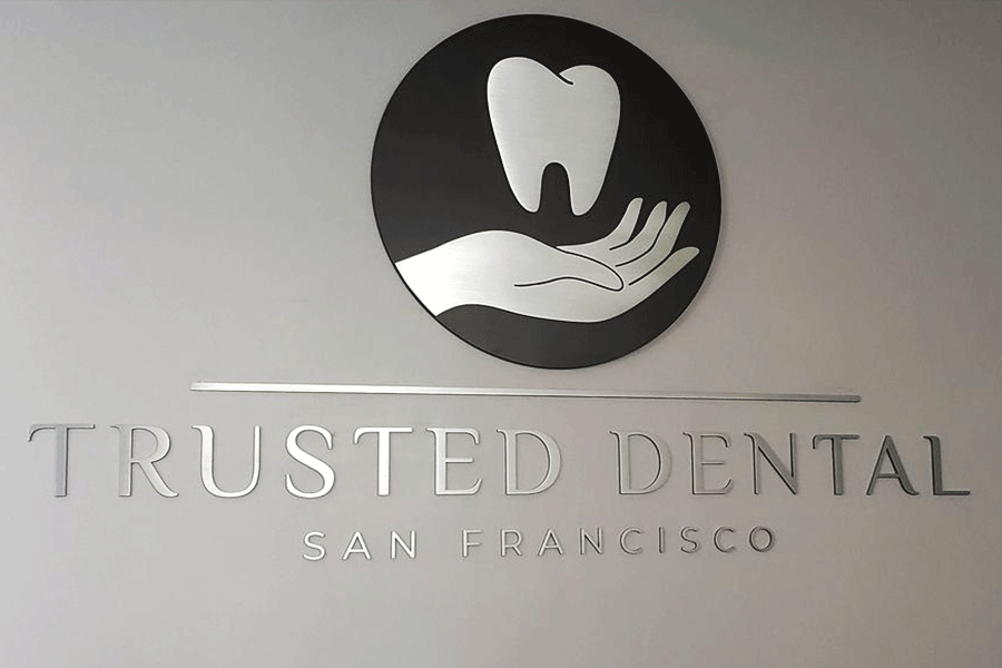 Dentist sign with polished stainless steel sign letters and logo.
