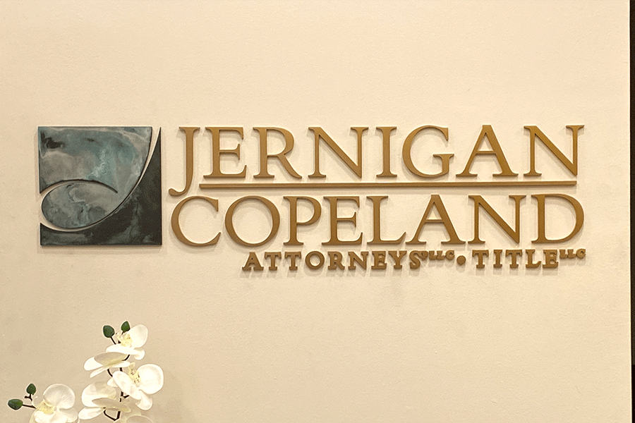 Law office sign with bronze sign letters and a verde patina bronze logo.