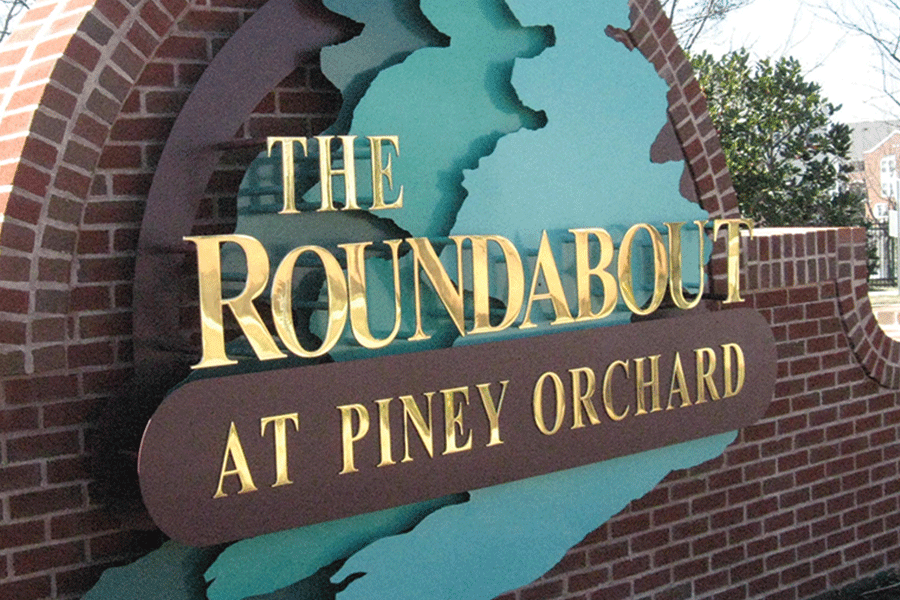 Residential development sign with polished brass sign letters.