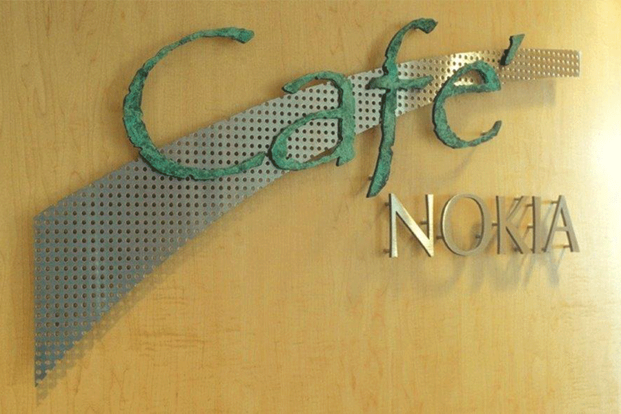 Cafe sign with verde patina brass and polished brass sign letters.