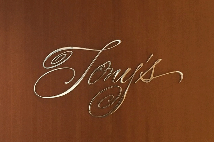 A restaurant sign with polished aluminum sign letters.