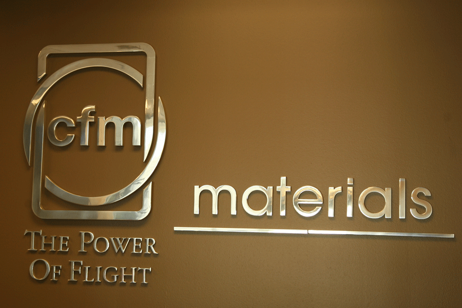 A lobby sign with polished aluminum sign letters and shapes.