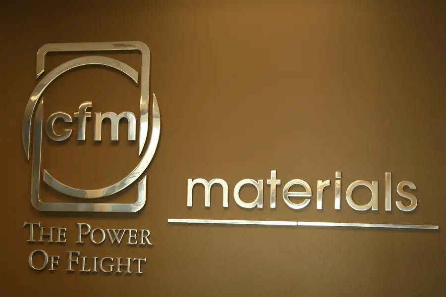 A lobby sign with polished aluminum sign letters and shapes.