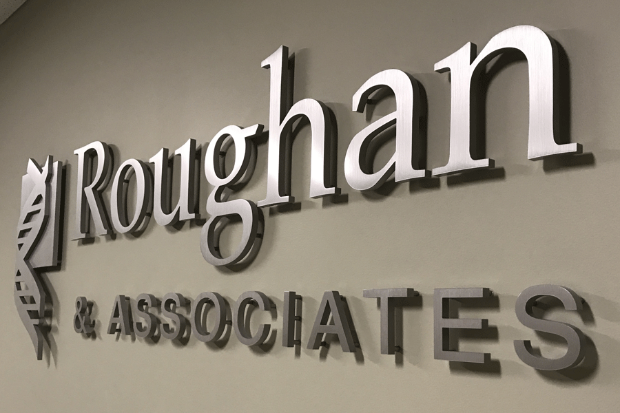 A law office sign with brushed aluminum sign letters.