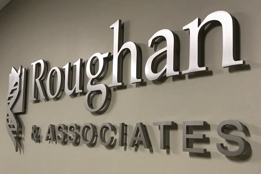 A law office sign with brushed aluminum sign letters.