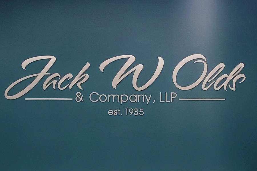 An interior wall sign with brushed aluminum sign letters.