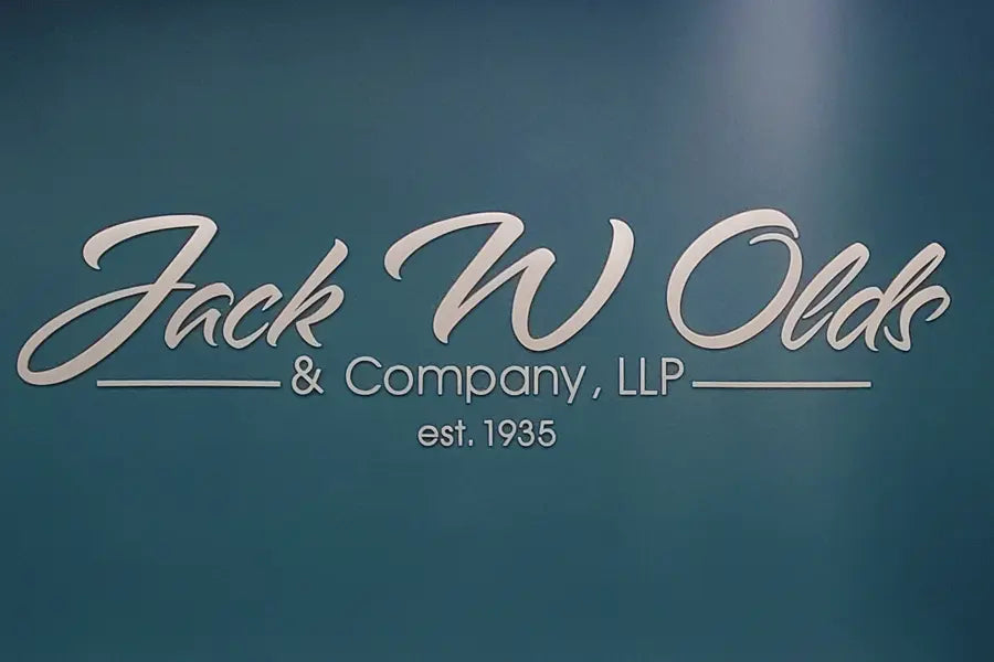 An interior wall sign with brushed aluminum sign letters.