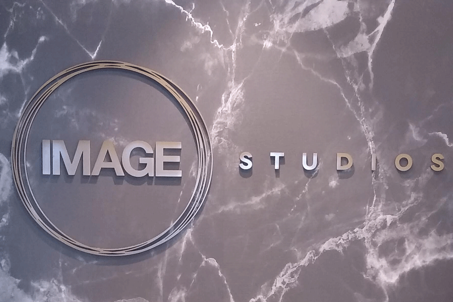 An interior lobby sign with brushed aluminum sign letters.