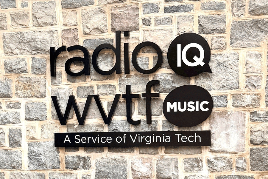 An exterior building sign for a radio station with black anodized aluminum sign letters.