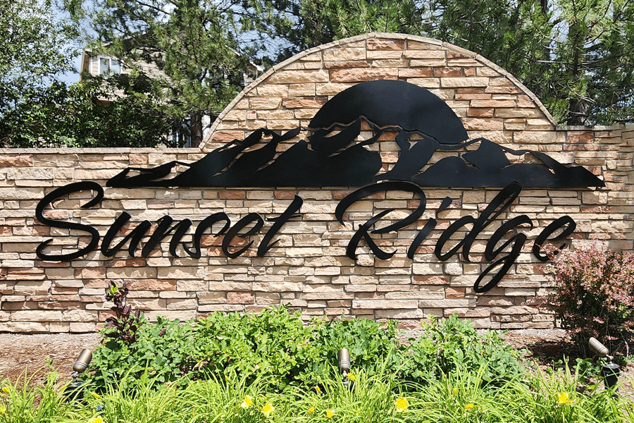 An exterior monument sign with black anodized aluminum sign letters and shapes.