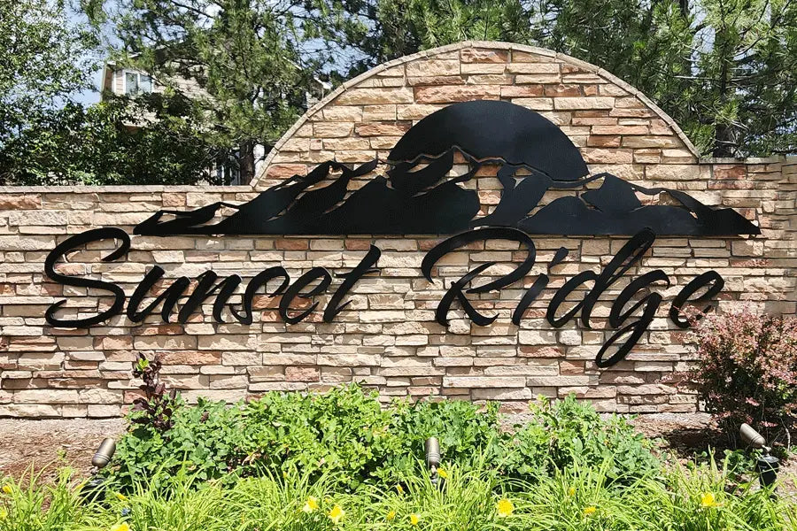 An exterior monument sign with black anodized aluminum sign letters and shapes.