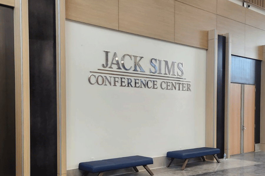 An interior conference center sign with polished aluminum sign letters.