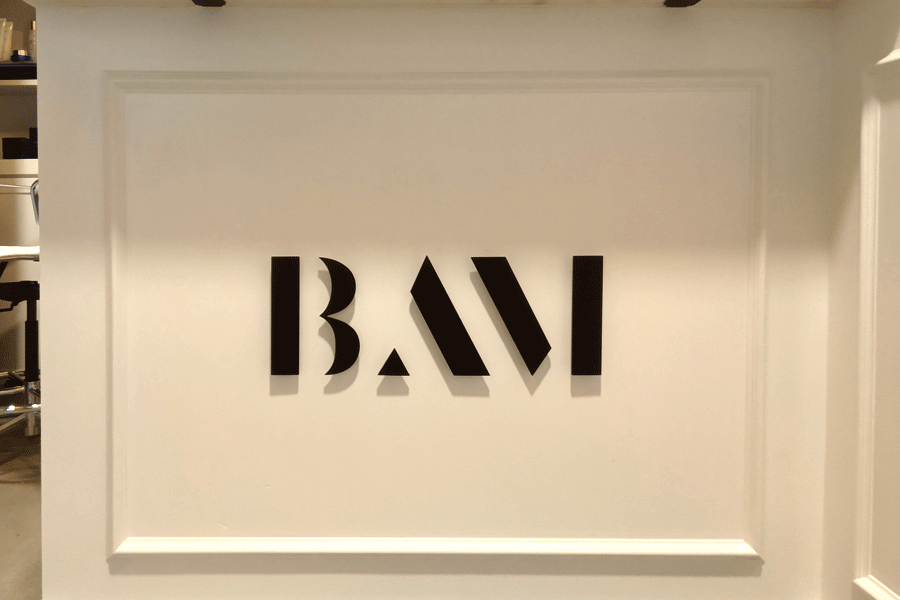 An interior office sign with black anodized aluminum sign letters.